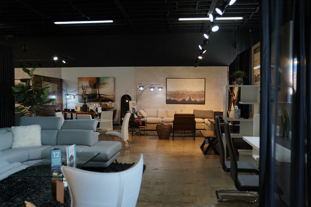 Caravana Furniture Showroom entrance featuring 2 sectionals and a dining set
