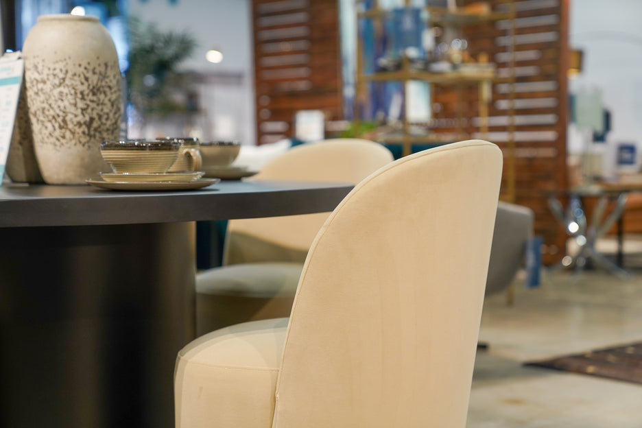 Closeup of Velvet cream color upholster chair and espresso color dining set