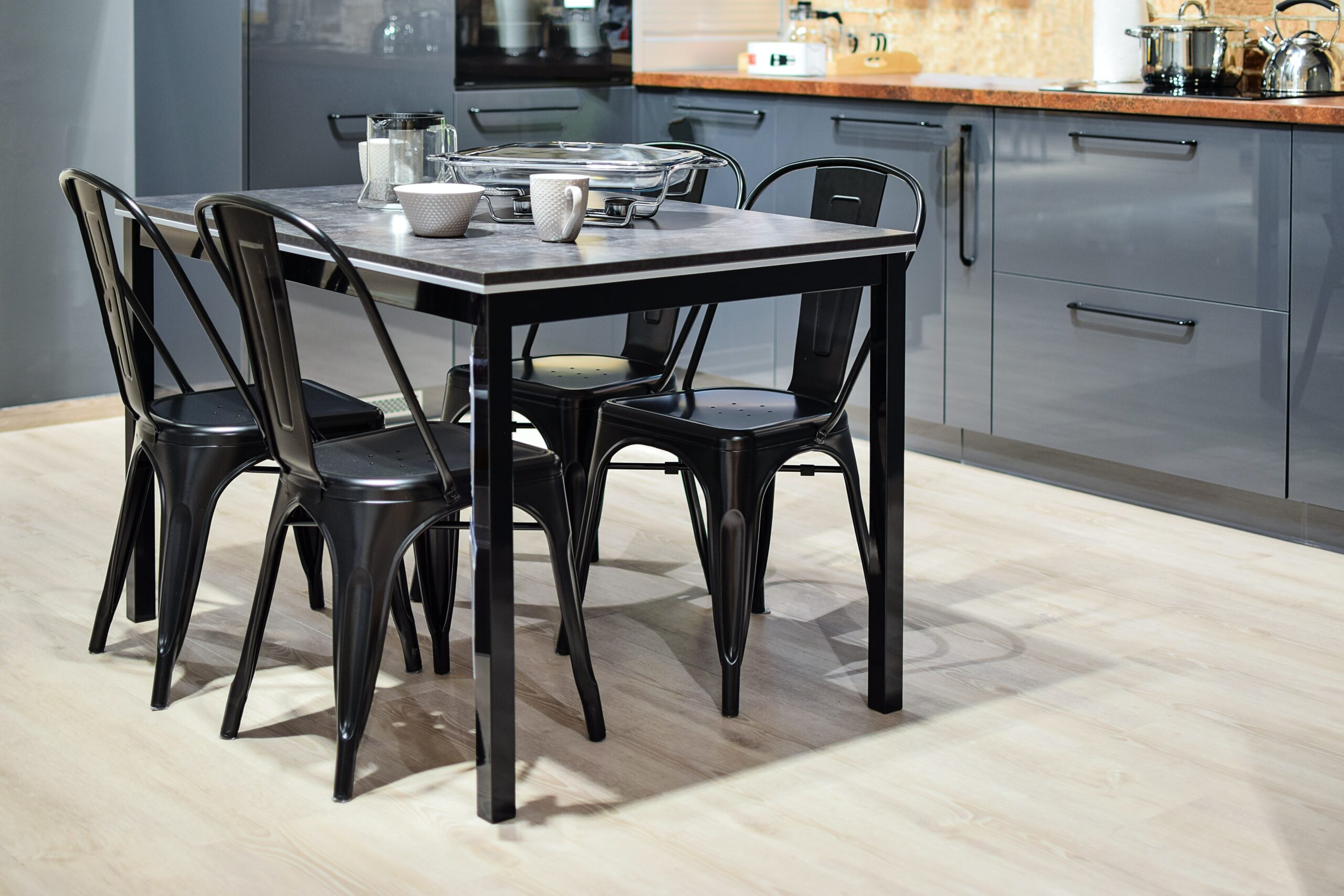 Black metal table with four chairs in kitchen
