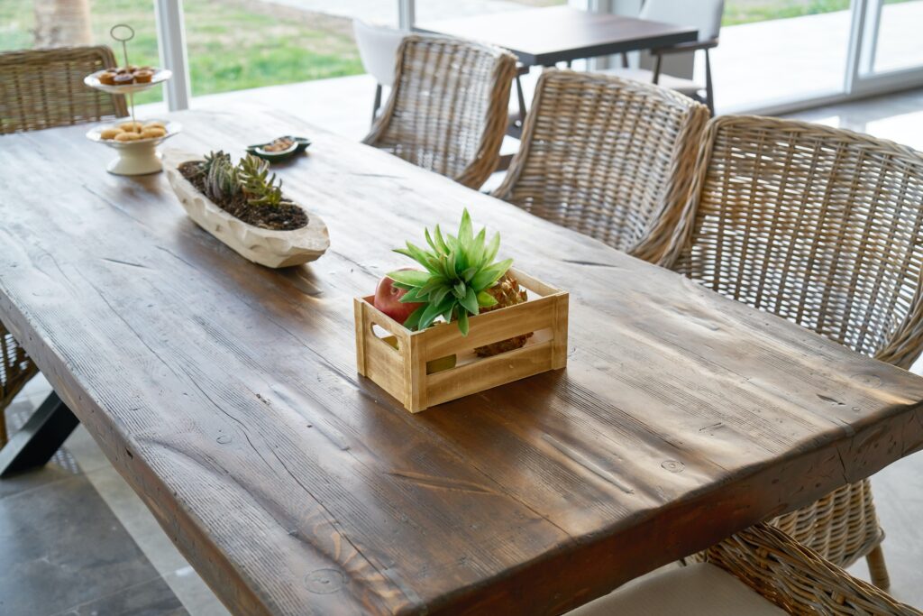 Farmhouse table surrounded by wicker chairs