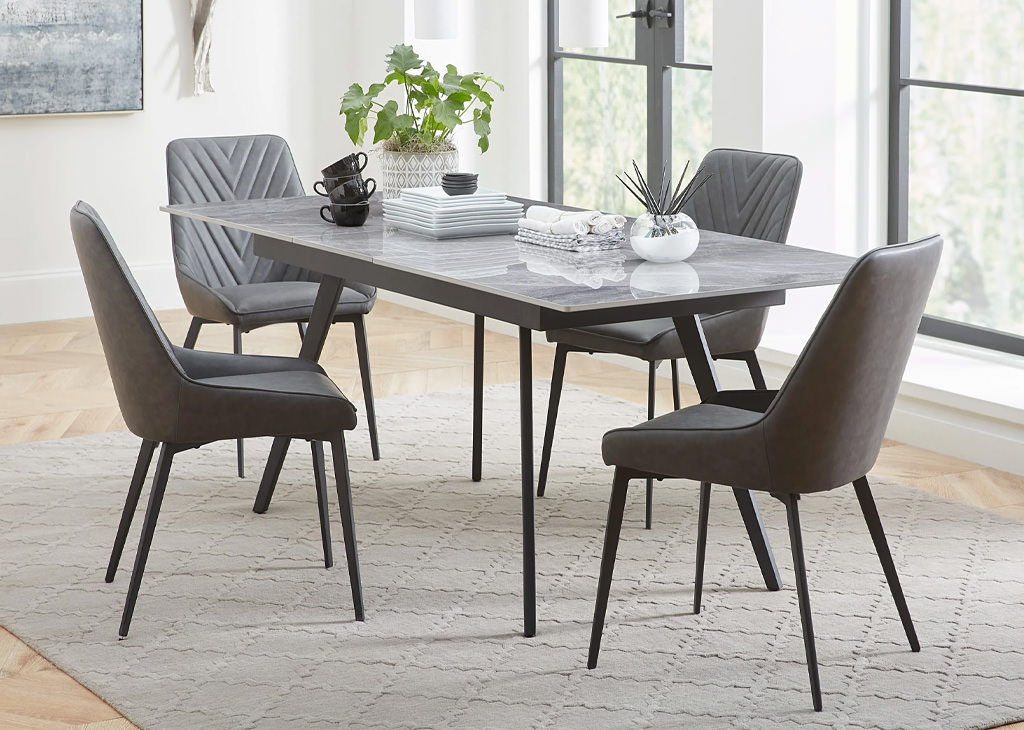 Extendable Stone-Top Dining table with 15" self-storing leaf mechanism and four charcoal-colored synthetic Leather Dining Chairs